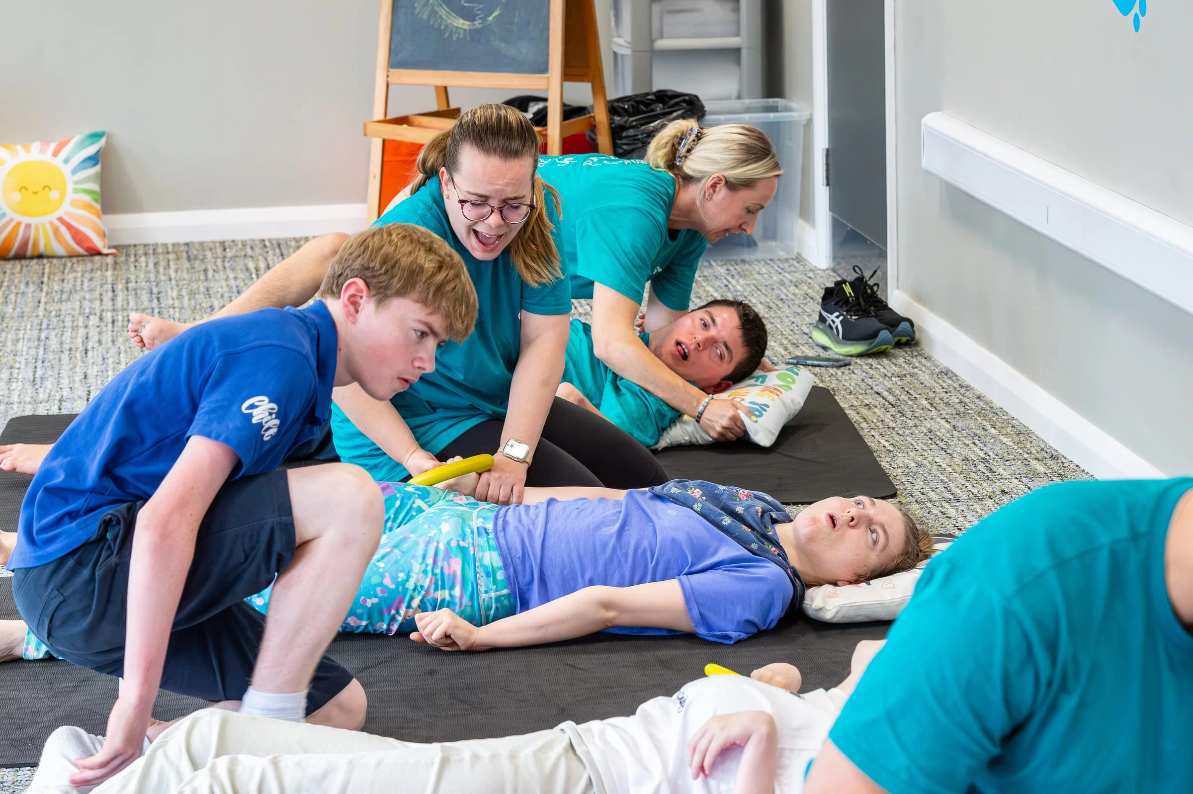 A therapist supporting a young person's arm through a range of movement