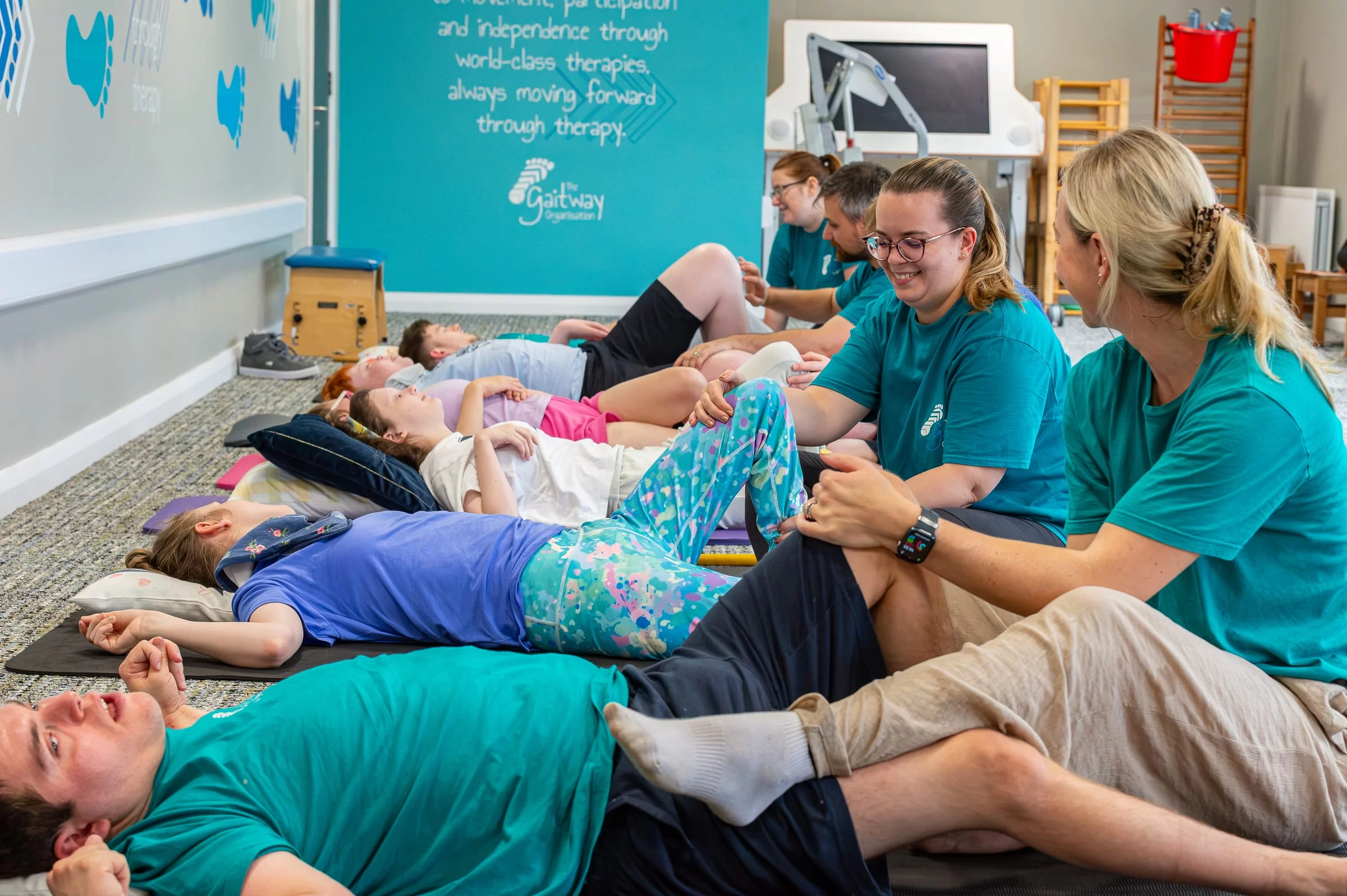 A wide view of the senior group session, several pairs working together beneath the strapline wall
