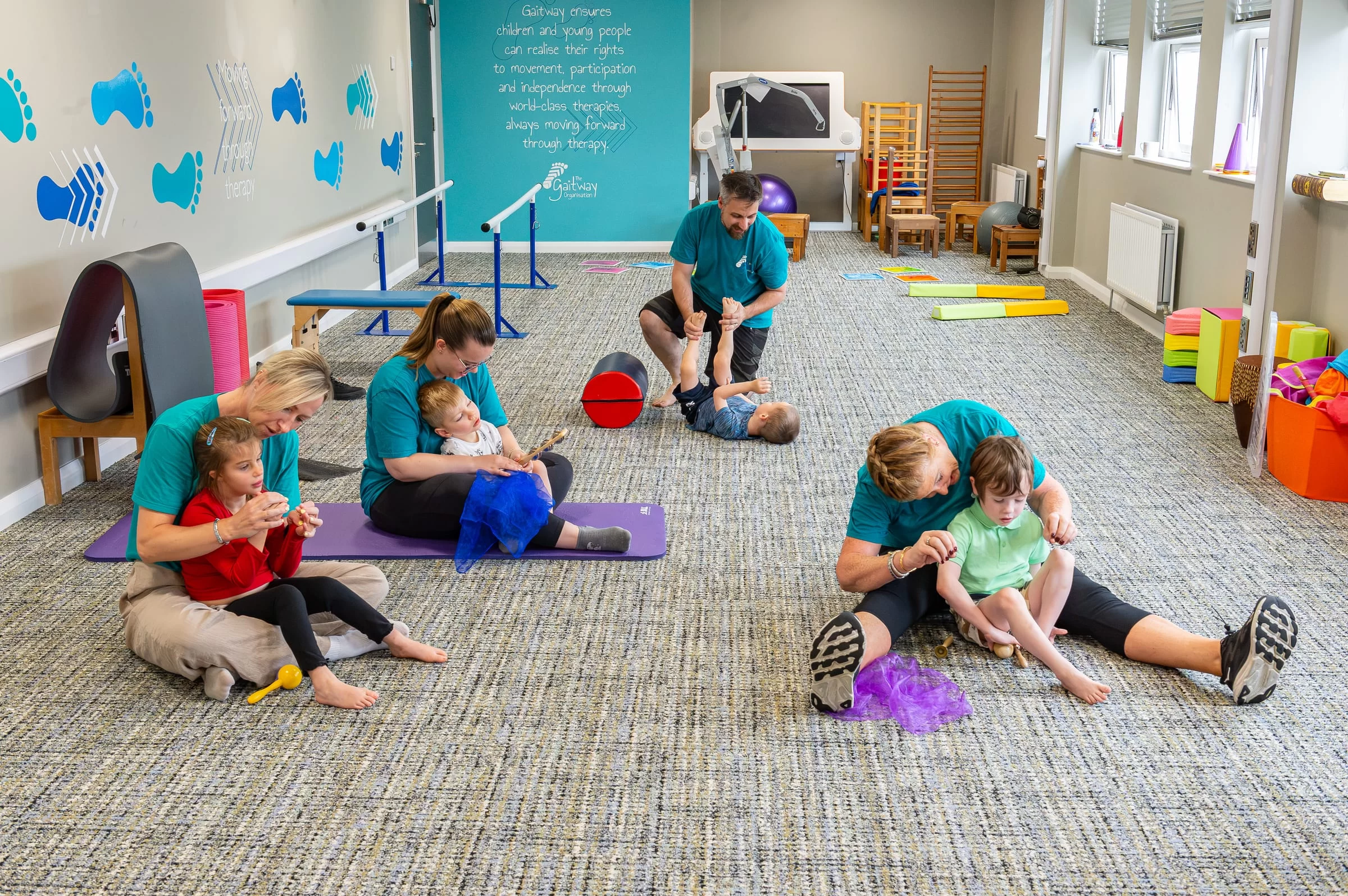 A wide view of the therapy room with several sessions running at once