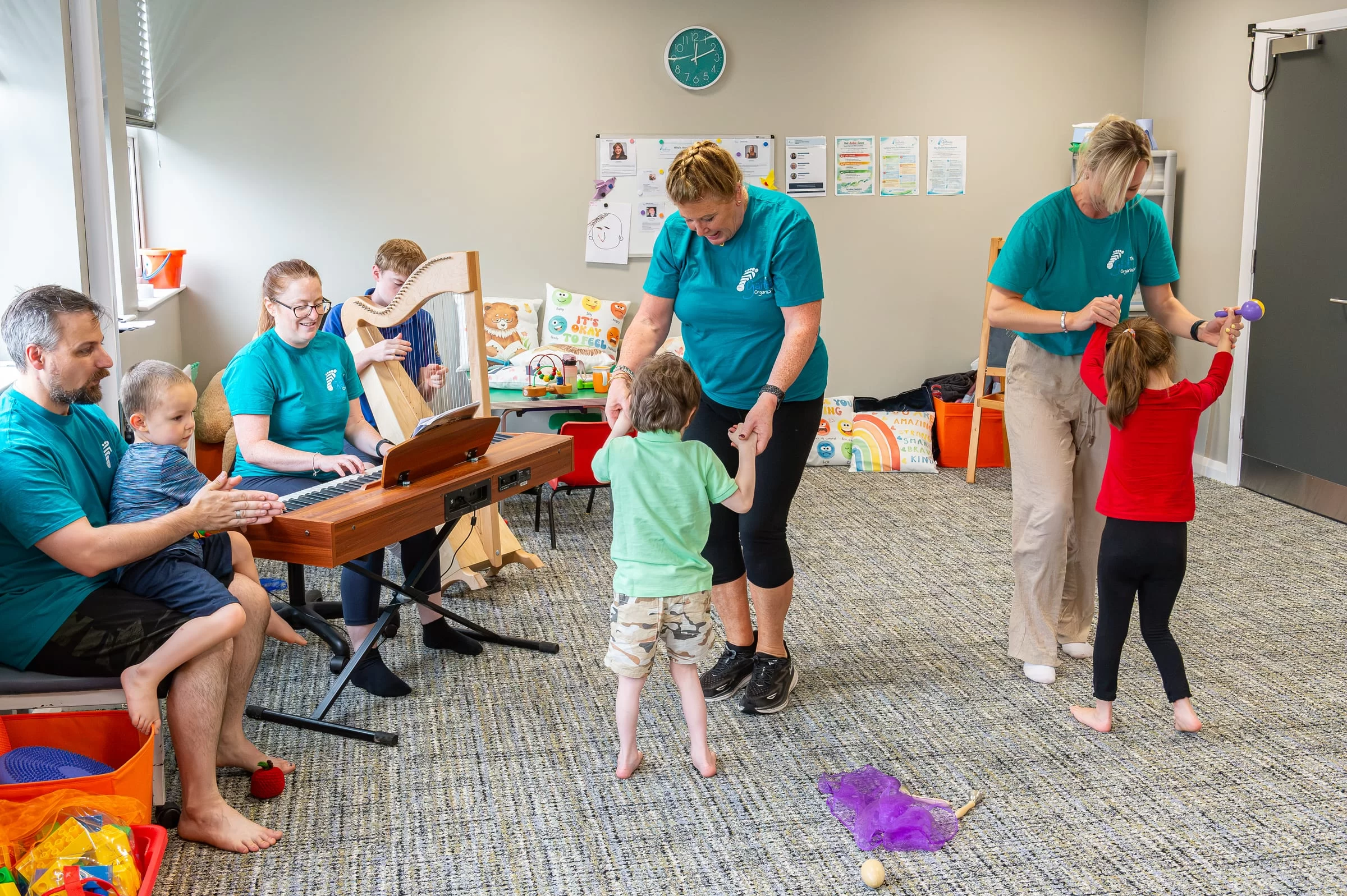 A group session with children and therapists taking part together in a music and movement activity